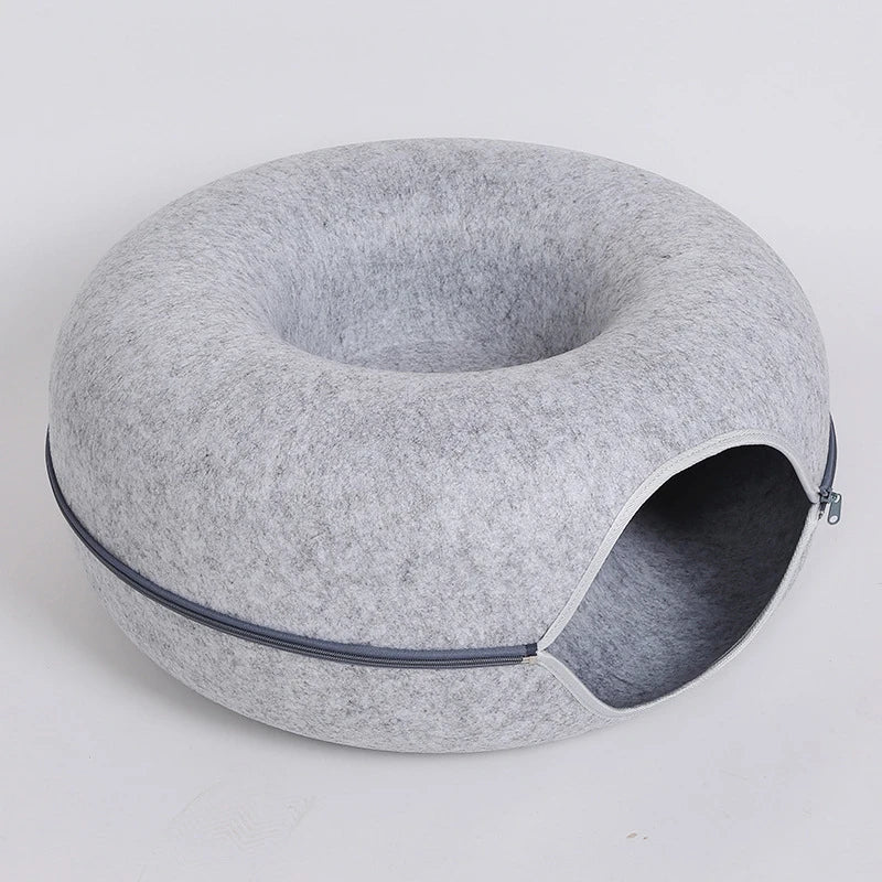 gray zippered donut-shaped cat tunnel bed made of felt with an open entrance